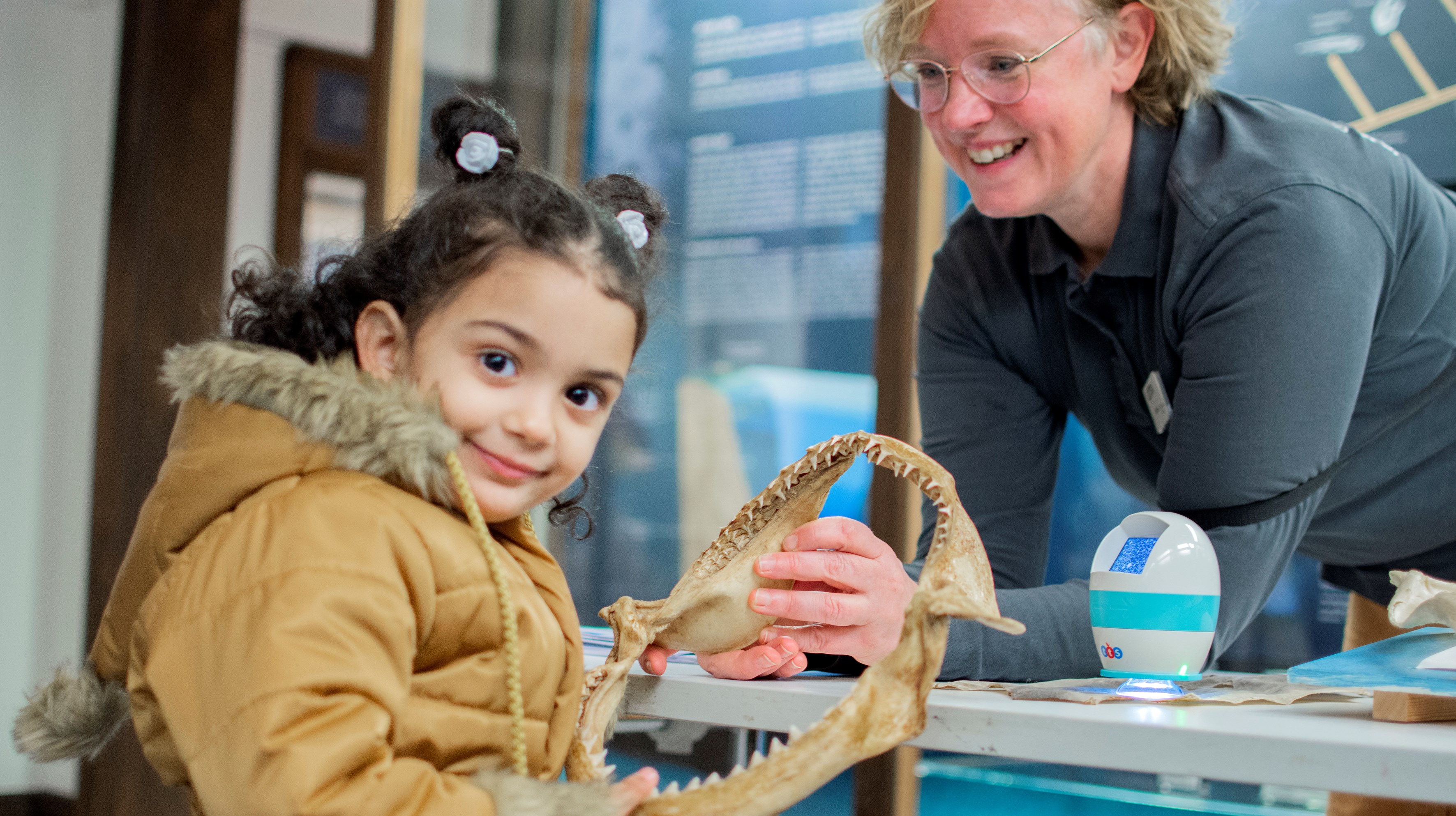 child holding shark teeth